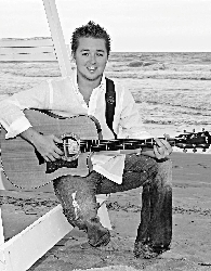 musician on beach in black and white
